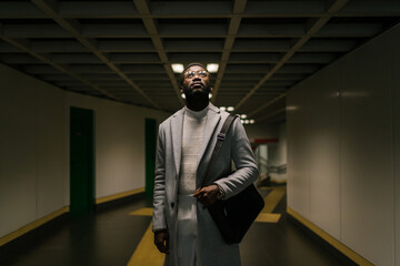 Elegant black man in underground corridor