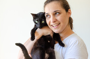 happy latin woman holding a black cat