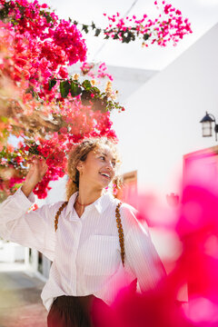 Happy girl among flowers