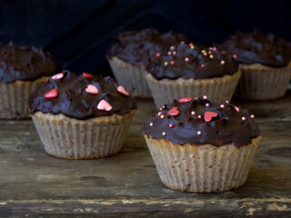 Freshly baked muffins with chocolate and beans. Healthy food concept. Savory pastry. Cupcakes on a wooden background