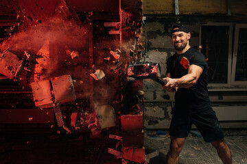 crossfit athlete crashing wall with sledgehammer