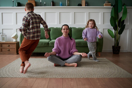 Children run around their mother