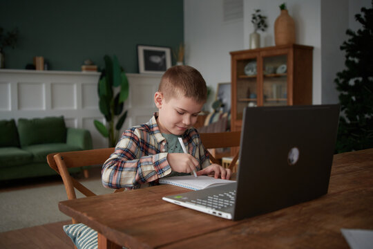 boy does schoolwork at home.