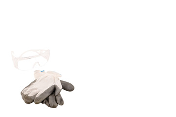 Impact-resistant safety goggles and safety gloves for hand protection on white background. Always wear your PPE concept