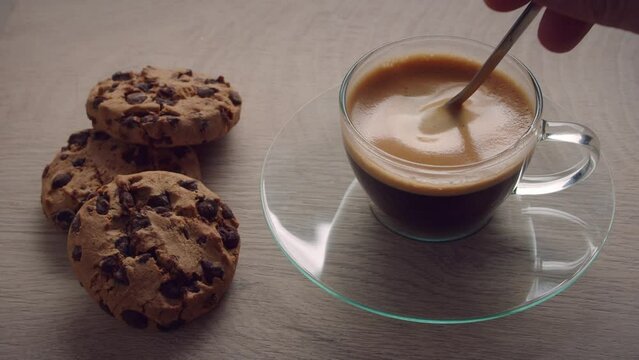 Top View Of Person Hand Stirring Coffee Espresso With Spoon
