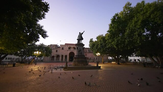 Moving forward to monument to Christopher Columbus in the evening. Light of street lanterns in Columbus Park with no people. Santo Domingo, Dominican Republic