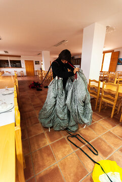 BASE jumper checking and assembling the parachute