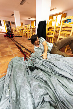 BASE jumper checking and assembling the parachute