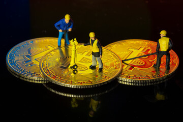 Concept of workers mining bit coin miniature people macro