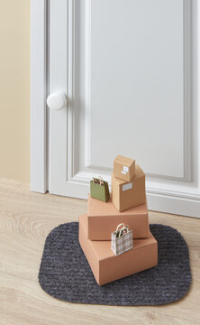 Shopping bags with cardboard boxes on door mat