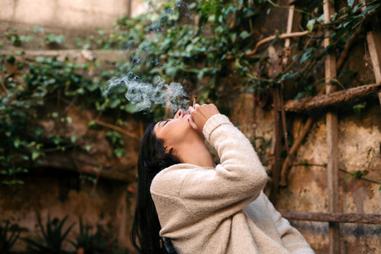 Woman smoking a CBD cigarette