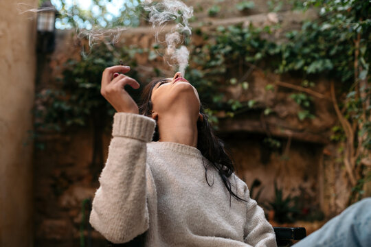 Woman smoking a CBD cigarette
