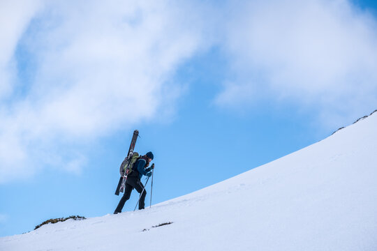 woman climbing uphill on a free rider skiing expedition 