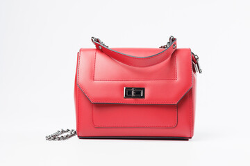 New women's red bag with bronze fittings on a white isolated background. New collection of leather bags