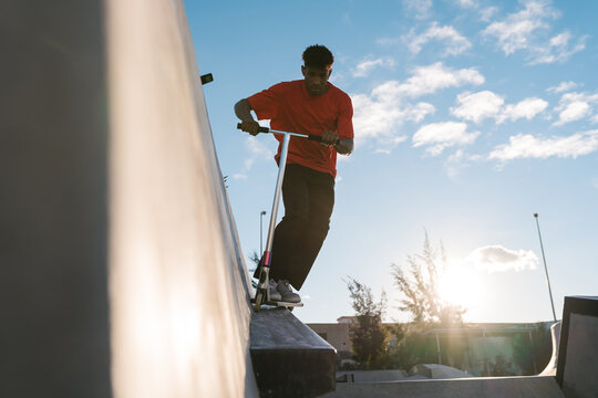 Boy doing a trick on a skateboard on the skate ramp