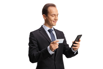 Businessman holding a credit card and using a smartphone
