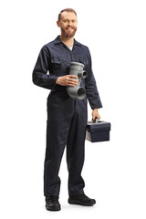 Full length portrait of a plumber holding a plastic pipe and a tool box - obrazy, fototapety, plakaty