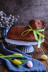Classic chocolate Easter lamb pound cake sprinkled with cocoa powder