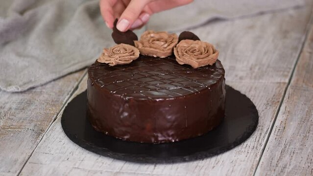 Chocolate cake with chocolate glaze and cream, Prague.