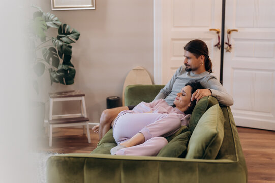 Couple playing with cat on couch