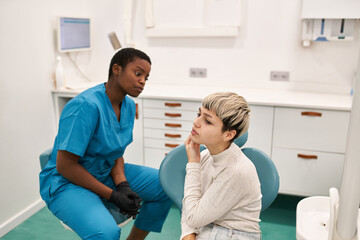 Young patient complaining to dentist
