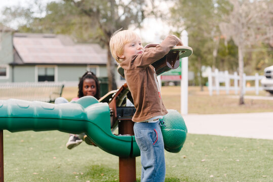 Boy and black girl on seesaw