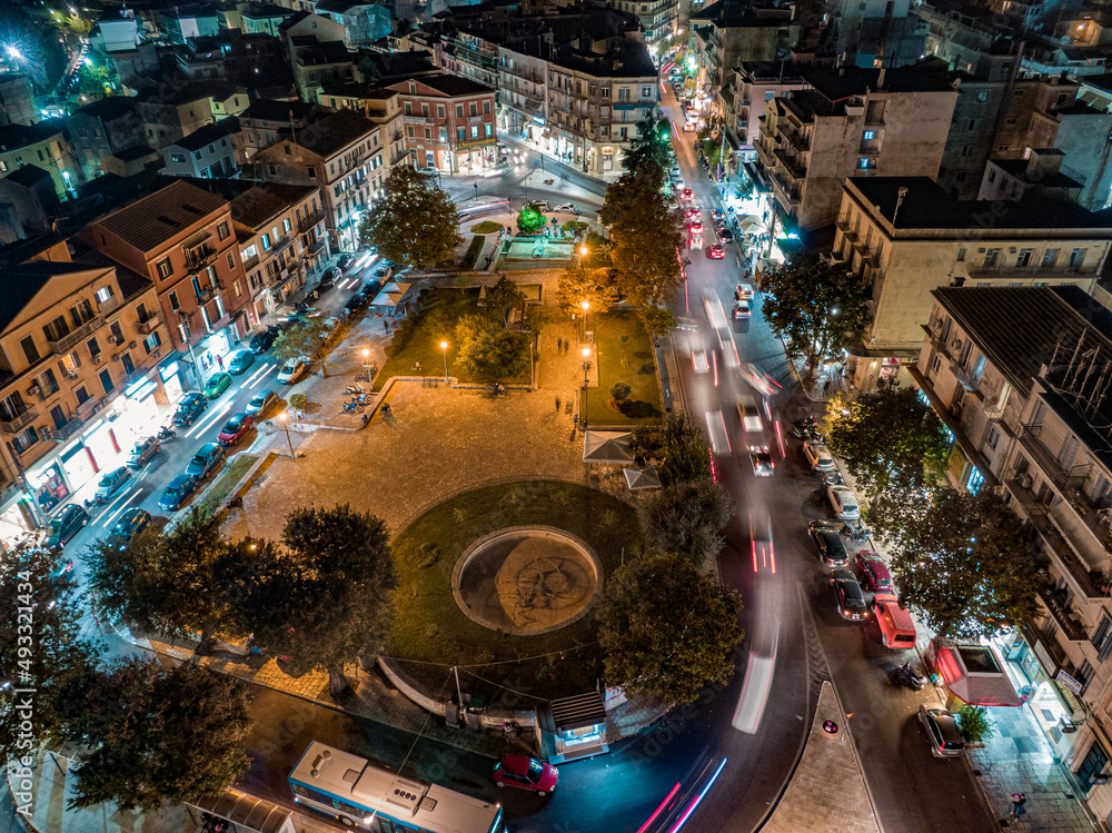 Wall mural panoramic aerial drone shot of the citylights of corfu city at night. kerkyra. corfu island. greece.