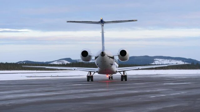 Small passenger aircraft on airport ready to take off in wintertime.