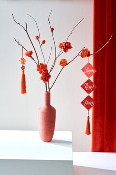 Vietnamese Tet decorations with red printed a word "Lunar new year" and plum blossom on red background