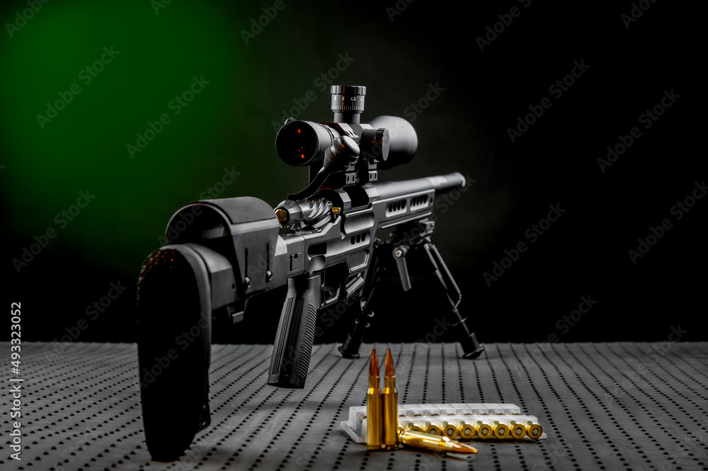 Poster modern powerful sniper rifle with a telescopic sight mounted on a bipod. ammo and an additional maga