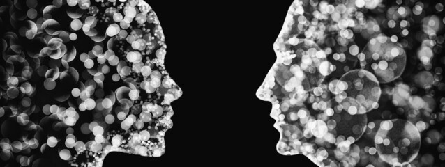 Zwei sich anschauene Silhouetten eines weiblichen und eines männlichen Kopfes - obrazy, fototapety, plakaty