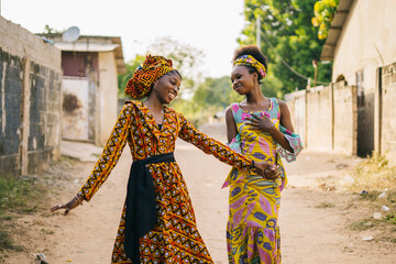 Happy African girls walking on street