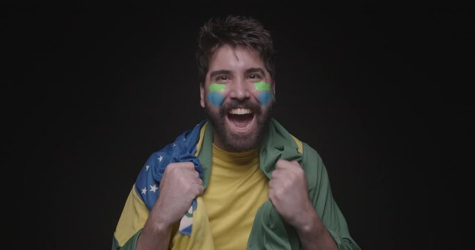 handsome man with brazilian beard, soccer fan, celebando, celebrating, vibrating watching the game. with clothes and flag of brazil, world cup, olympics.