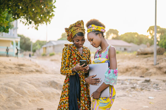 Authentic African woman using smartphone in village