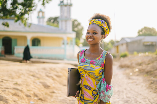 African girl with laptop on street