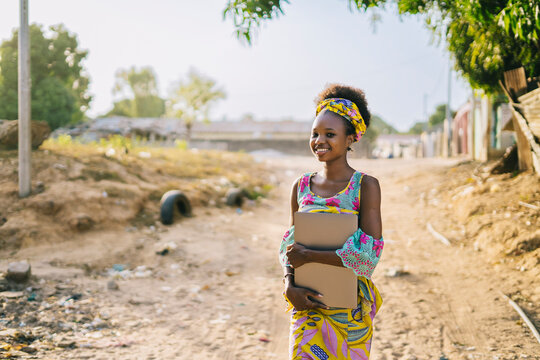African girl with laptop in village