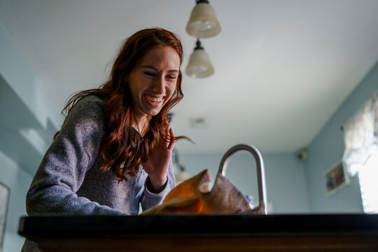 A Young White Woman Cleans The House.