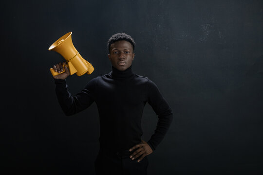 Portrait of a guy with a bright megaphone