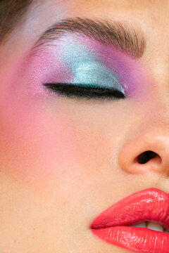 Vertical photo an eye closed with multicolored eyeshadow
