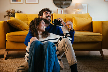 Happy couple laughing and caressing dog