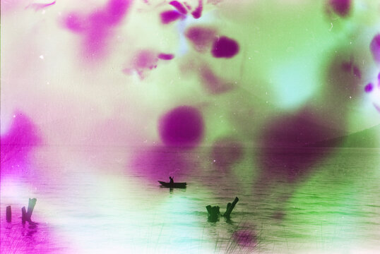 double exposure of man in a boat with pink dyes