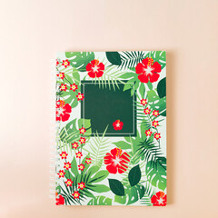 Floral notebook on pastel coral background