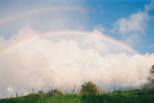 rainbow in blue sky  