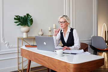 Mature woman working at office.