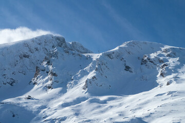 mountain peak covered in snow and clear blue sky