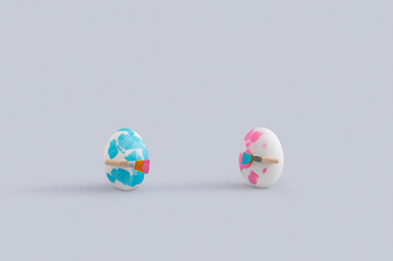 Funny Easter concept with two painted eggs with paintbrushes