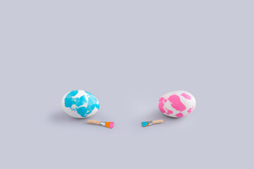 Creative Easter concept with two painted eggs with paintbrushes