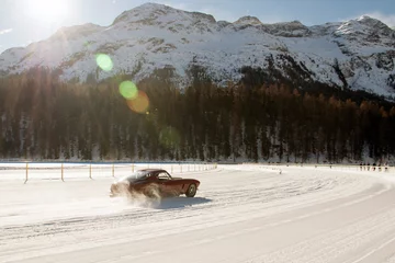 Zelfklevend Fotobehang Vintage sports car on the frozen lake of St moritz © CoolimagesCo
