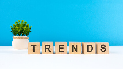 the word trends is written on wooden cubes on a light blue background