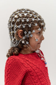 Portrait of a toddler in EEG cap in a lab